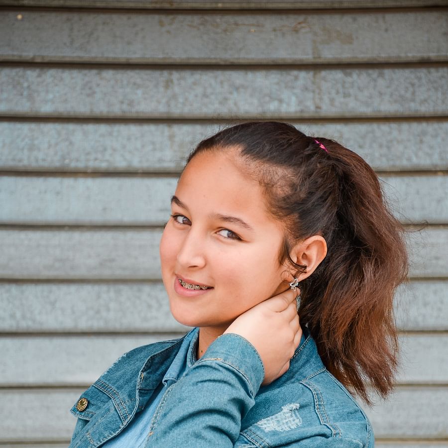 Cheerful individual showing off their dental braces with a bright smile