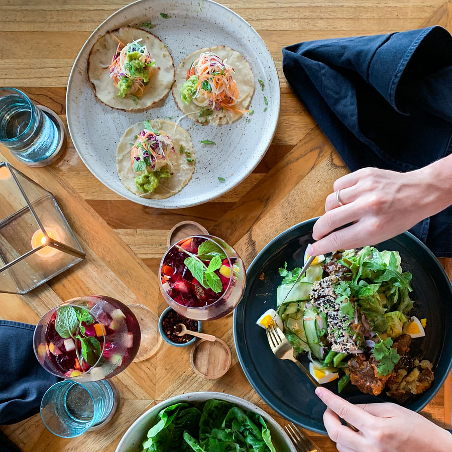 Person with braces smiling and enjoying a healthy meal